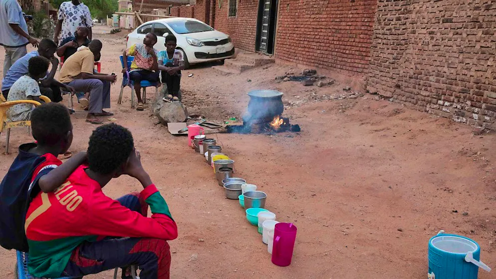 ARCHIVE - People prepare food in a neighborhood of Khartoum. Photo: -/AP/dpa