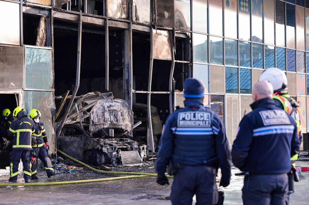 Des pompiers et des policiers à la bibliothèque Chantal-Maudit, incendiée pendant la nuit à Grenoble par une voiture, le 19 février 2025.