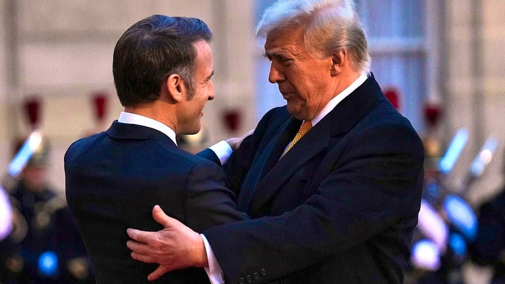 ARCHIVE - French President Emmanuel Macron (l) embraces Donald Trump on his arrival at the Elysee Palace. Photo: Aurelien Morissard/AP/dpa/archived image