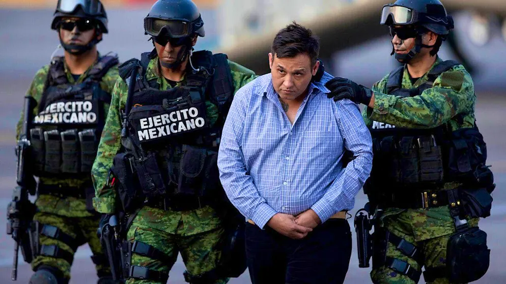 dpatopbilder - ARCHIVE - Soldiers escort a man identified by authorities as Omar Trevino Morales, alias "Z-42," leader of the Zetas drug cartel, as he is taken from a military plane to a military vehicle in the hangar of the Attorney General's Office. Photo: Eduardo Verdugo/AP/dpa