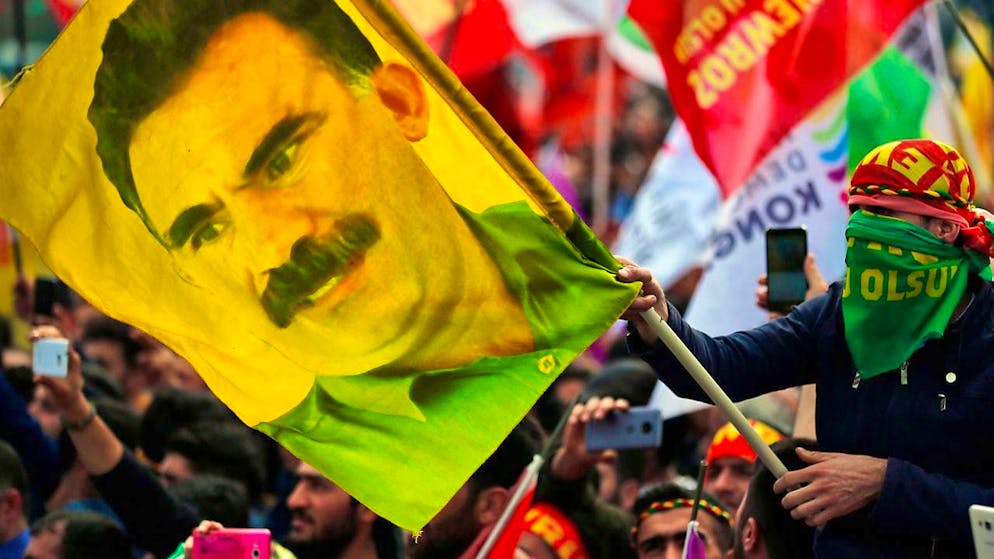 ARCHIVE - A youth holds a flag with the picture of the imprisoned leader of the banned Kurdistan Workers' Party (PKK), Öcalan. Photo: Lefteris Pitarakis/AP/dpa/Archive photo