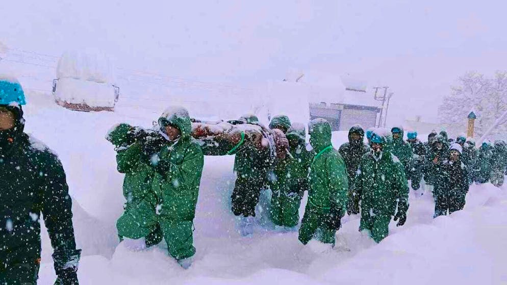 In this photo provided by the Indian Army, a team carries out rescue operations for trapped construction workers who were swept away by an avalanche near the Mana Pass.