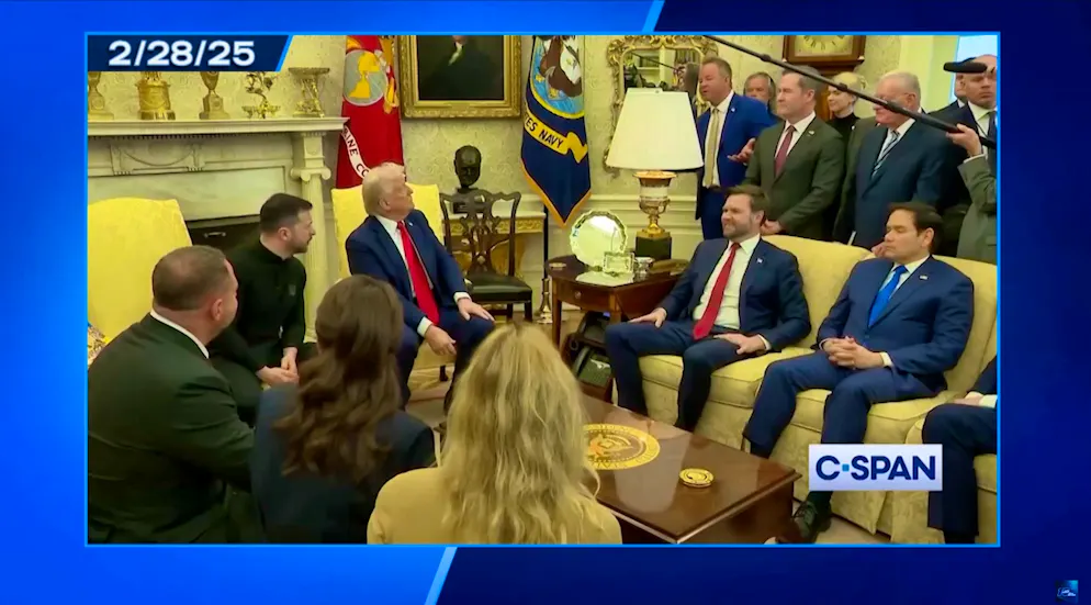 Journalist Brian Glenn (to the right of the lampshade) asks if Selenskyj owns a suit.