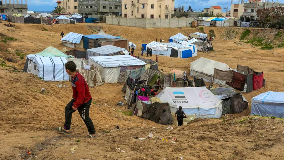 A child looks at the tents of displaced Palestinians in Al Mawasi. Israel continues to prevent access to mobile shelters for displaced Palestinians whose homes were destroyed by the Israeli army before its withdrawal from some Gaza Strip towns. Photo: Abed Rahim Khatib/dpa