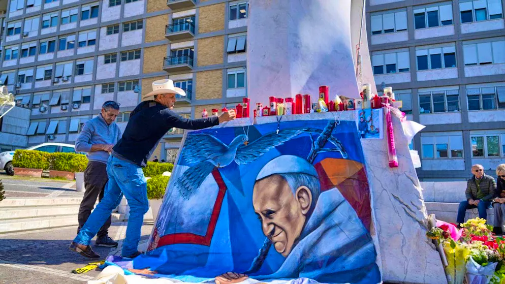 dpatopbilder - Mexican painter Roberto Marquez places a picture he painted of Pope Francis in front of the Agostino Gemelli Hospital in Rome. Photo: Gregorio Borgia/AP/dpa