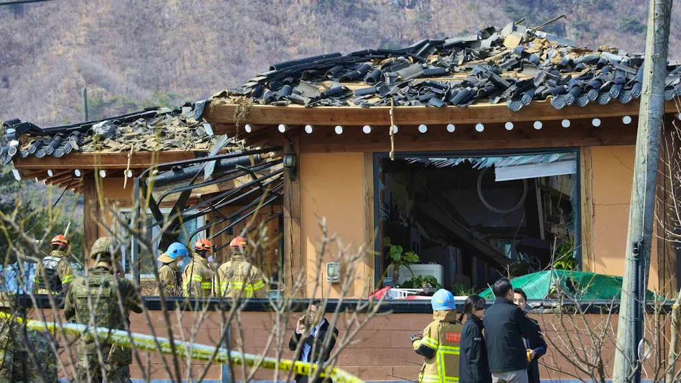 Rescue workers in front of a house that was accidentally hit by a bomb on Thursday.