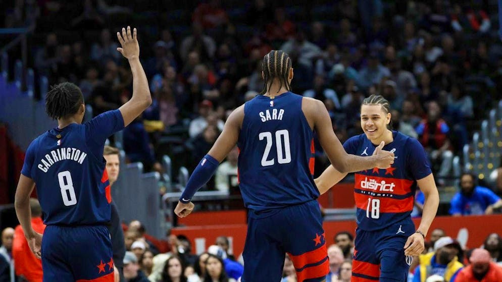 Kyshawn George of the Washington Wizards celebrates a successful evening with teammate Alex Sarr