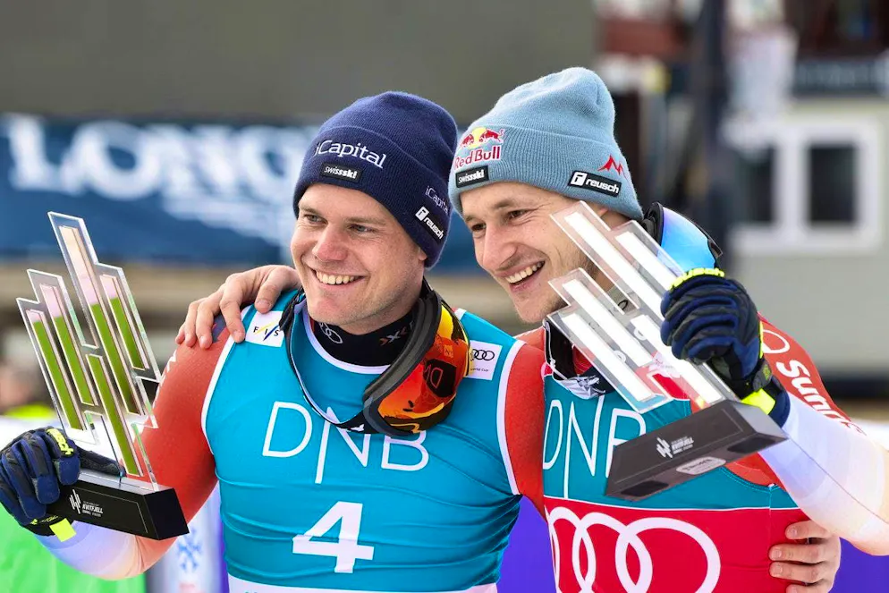 Marco Odermatt and Stefan Rogentin stand together on the downhill podium in Kvitfjell.