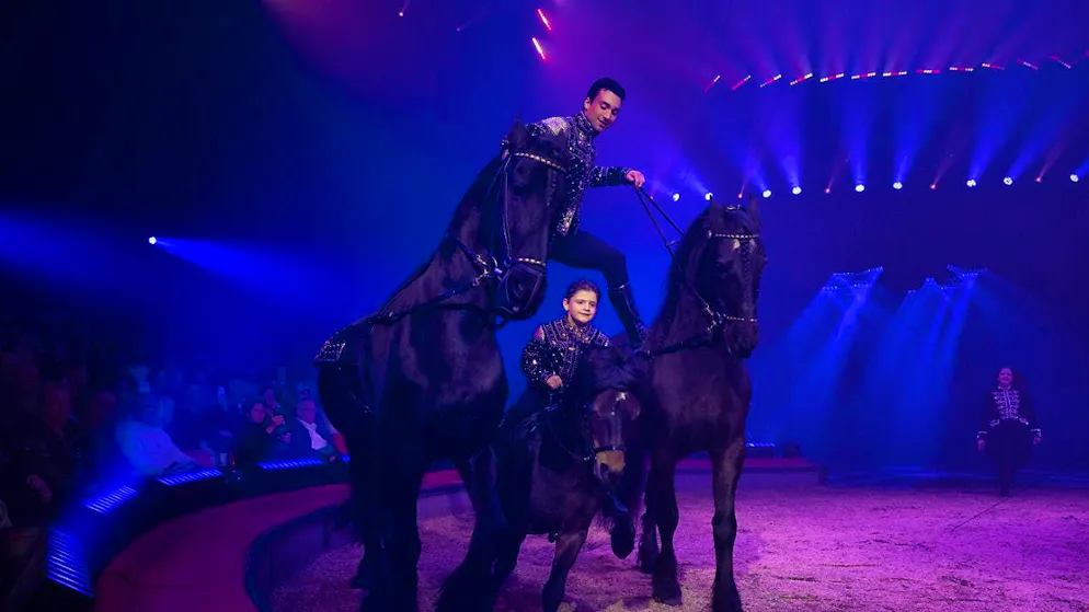 Seven-year-old Maycol Knie rides through the Circus Knie premiere under half-brother Ivan and receives a standing ovation.