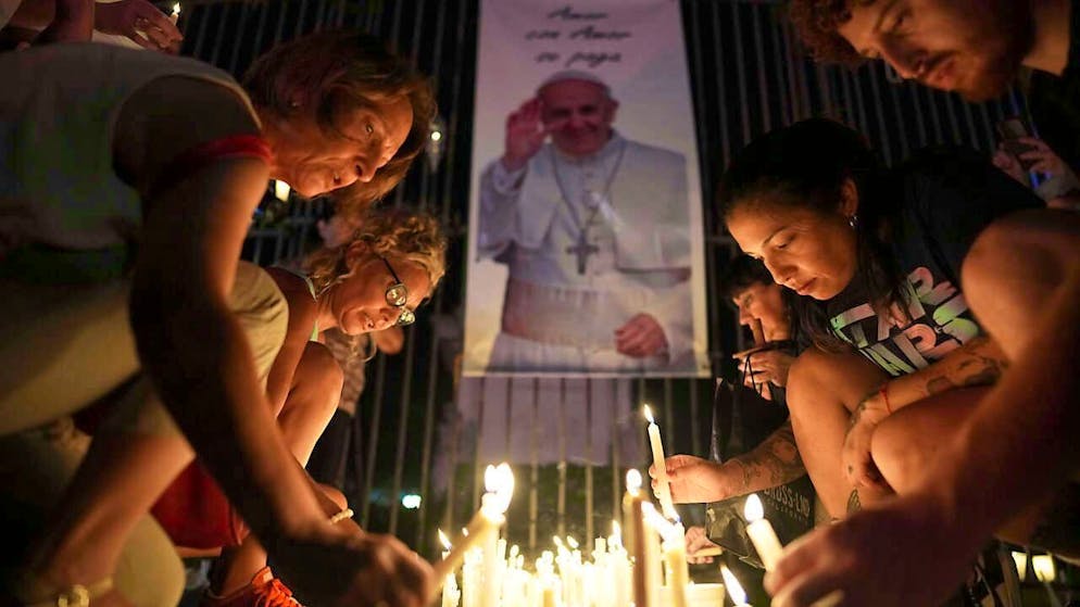 Believers light candles for Pope Francis during a vigil in Buenos Aires. Photo: Rodrigo Abd/AP/dpa