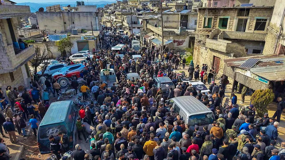 Relatives and neighbors take part in a funeral procession in the village of Al-Janoudiya west of Idlib for four Syrian security forces who were killed in clashes with supporters of ousted President al-Assad. Photo: Omar Albam/AP/dpa