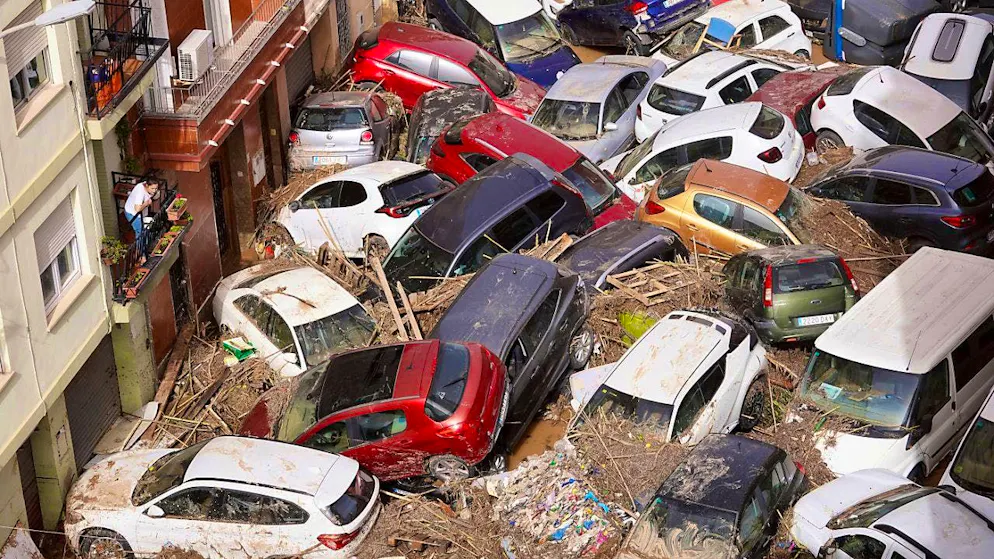 ARCHIVE - Residents look at cars piled up by the masses of water in Valencia. Photo: Alberto Saiz/AP/dpa/Archive image