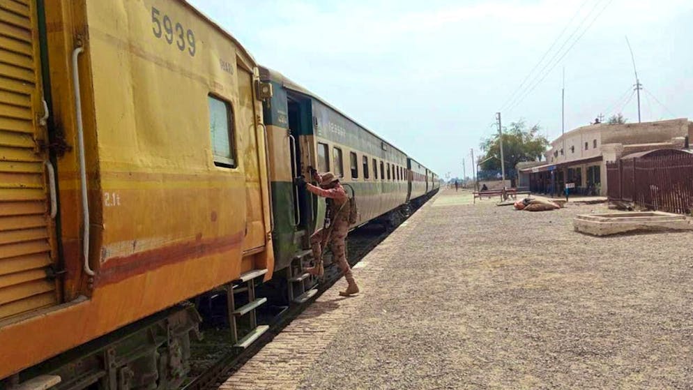 dpatopbilder - A paramilitary soldier takes up position at a train station near an attack on a passenger train. Photo: Uncredited/AP/dpa