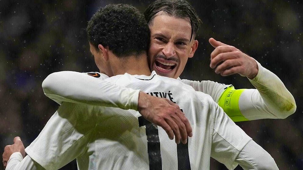 Frankfurt's Hugo Ekitiké and Robin Koch celebrate progressing in the duel with Ajax Amsterdam