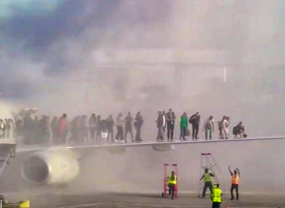 Passengers take refuge from the fire on the wing.