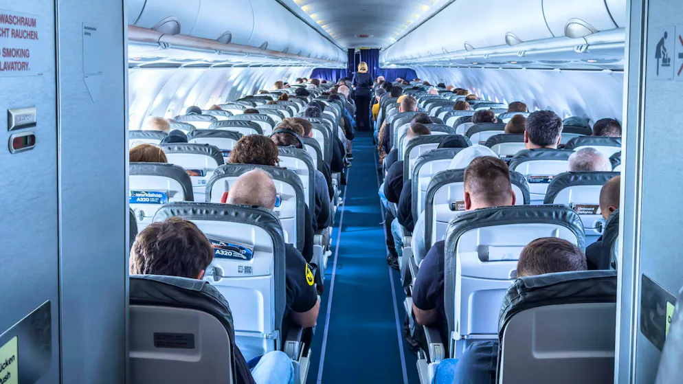 Passengers on an airplane. Some airlines have introduced new regulations regarding the storage of power banks.