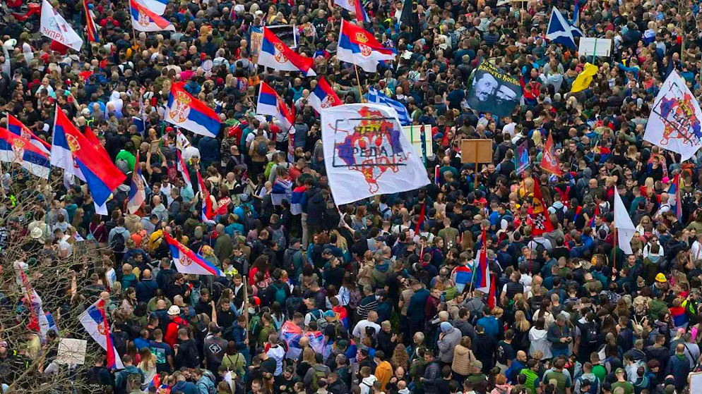 Demonstrators wave Serbian flags and gather near the Serbian parliament during a large anti-corruption rally led by university students. Photo: Marko Drobnjakovic/AP/dpa