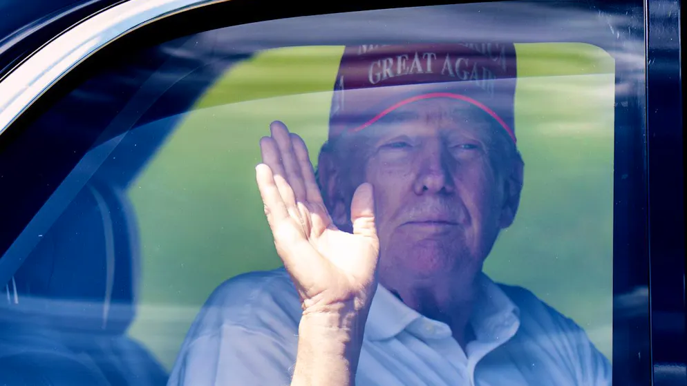 US-Präsident Donald Trump winkt aus seiner Limousine, die ihn von seinem Golfplatz in West Palm Beach zu seinem Mar-a-Lago-Anwesen chauffiert. (15. März 2025)