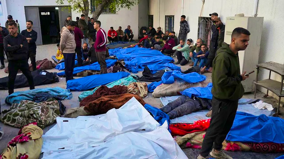 The bodies of Palestinians killed in an Israeli army airstrike. Photo: Abdel Kareem Hana/AP/dpa