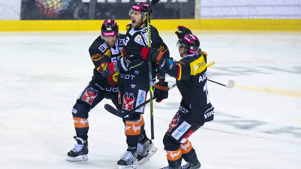Romain Loeffel, Lukas Klok and Miro Aaltonen, from left, celebrate Bern's winning goal in overtime.