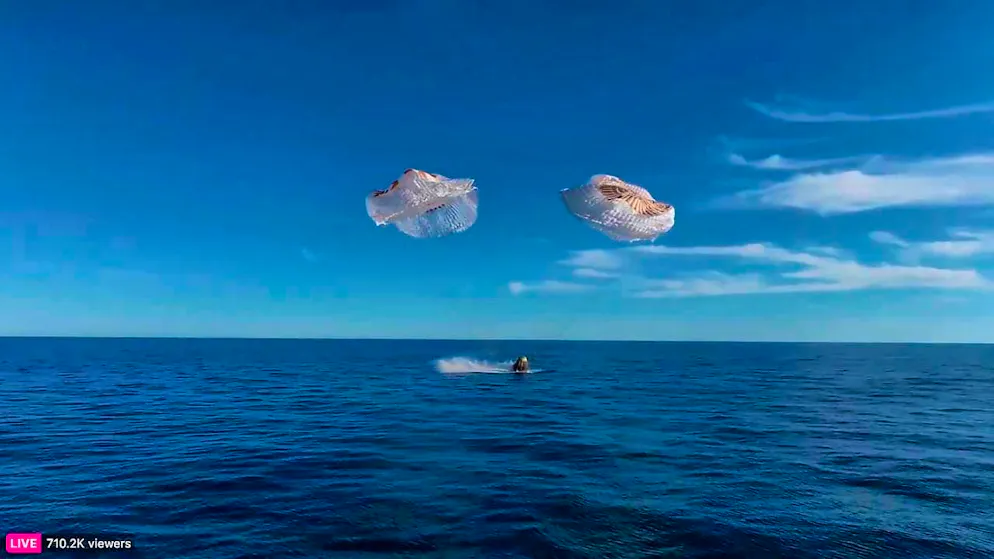 This image from a video released by SpaceX shows a SpaceX capsule parachuting into the Gulf of Mexico.