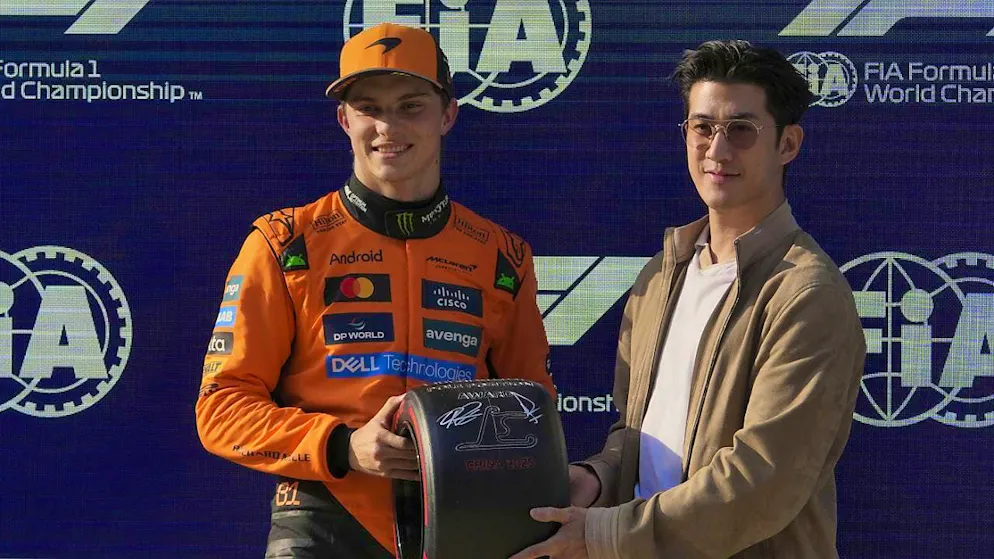 Oscar Piastri in the orange McLaren overall is delighted with his first pole position in Formula 1.