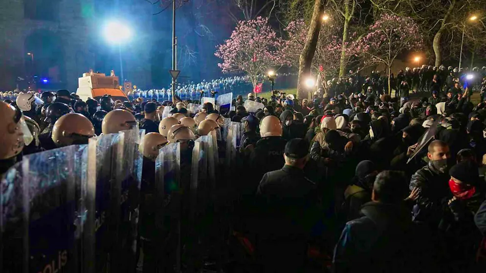 Protesters stand next to police during a demonstration against the arrest of Istanbul Mayor Imamoglu. Photo: Khalil Hamra/AP/dpa