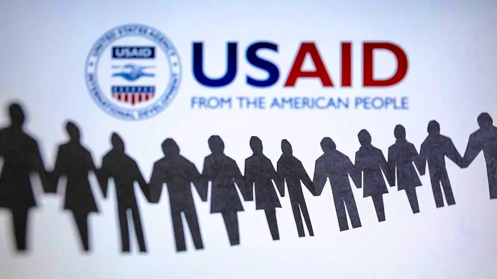 ARCHIVE - The logo of the United States Agency for International Development (USAID) can be seen behind a chain of cut-out paper figures. Photo: Andre M. Chang/ZUMA Press Wire/dpa