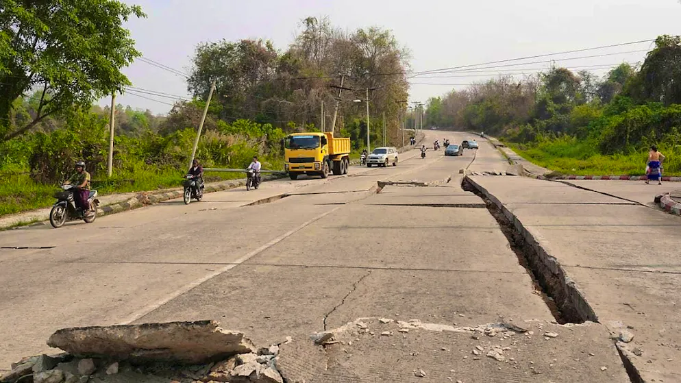 Vehicles make their way near a road damaged by an earthquake. Photo: Aung Shine Oo/AP/dpa