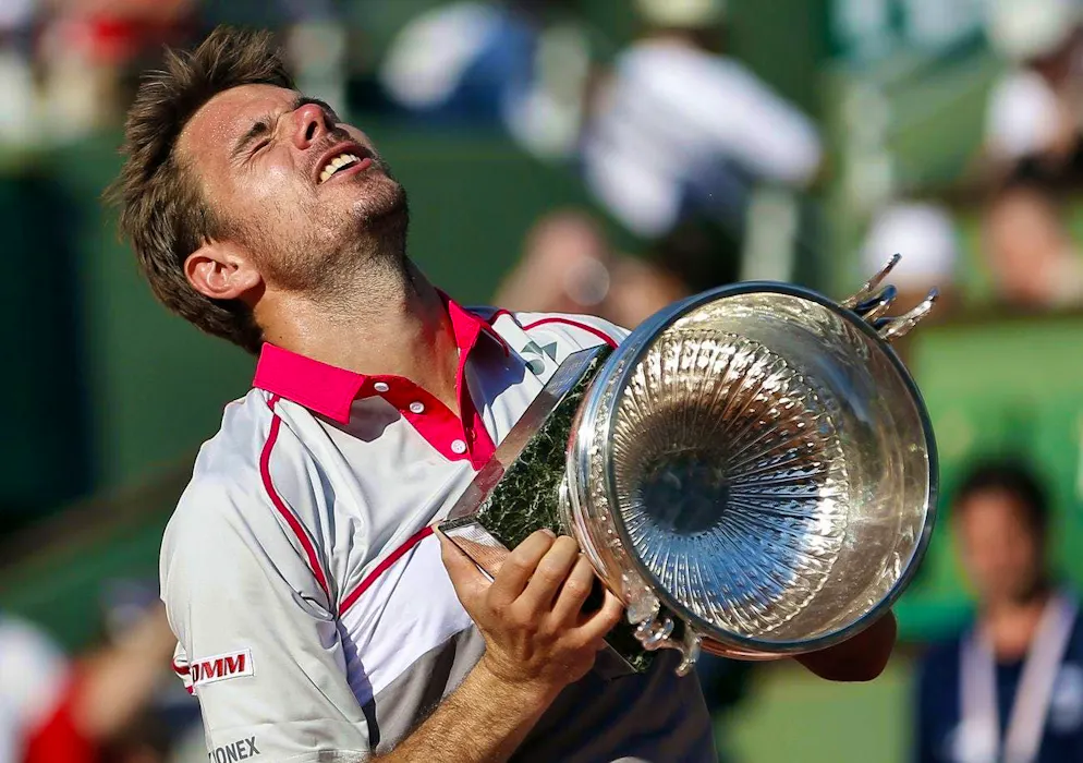 Stan Wawrinka celebrates his victory at the 2015 French Open. On June 7, 2015, he defeated Novak Djokovic in the final at Roland Garros and proudly poses with the trophy - a milestone in his career.