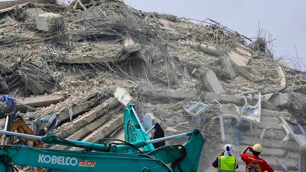 Rescue workers examine rubble at the construction site of a high-rise building in Bangkok that collapsed after Friday's earthquake. Photo: Manish Swarup/AP/dpa