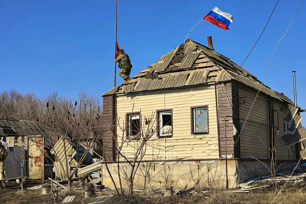 Soldiers hoist the Russian flag in a village in Kursk on March 14.