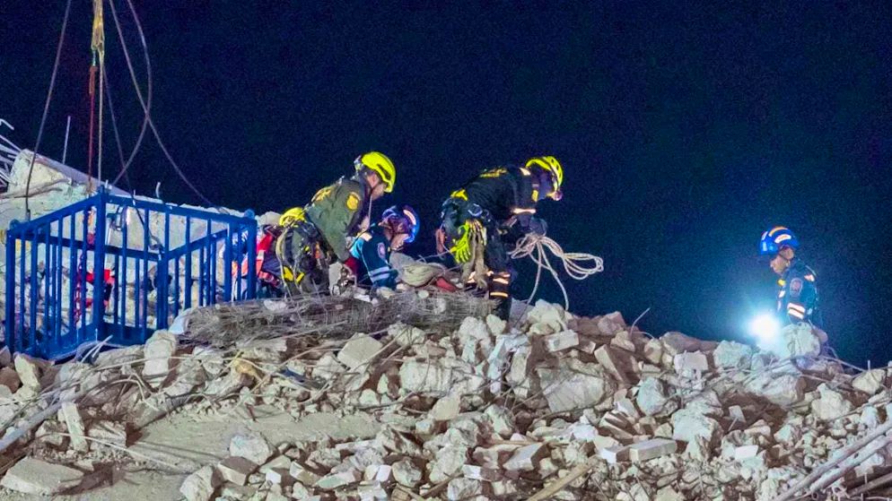 Rescue workers work at the construction site of a high-rise building that collapsed after an earthquake. Photo: Wason Wanichakorn/AP/dpa