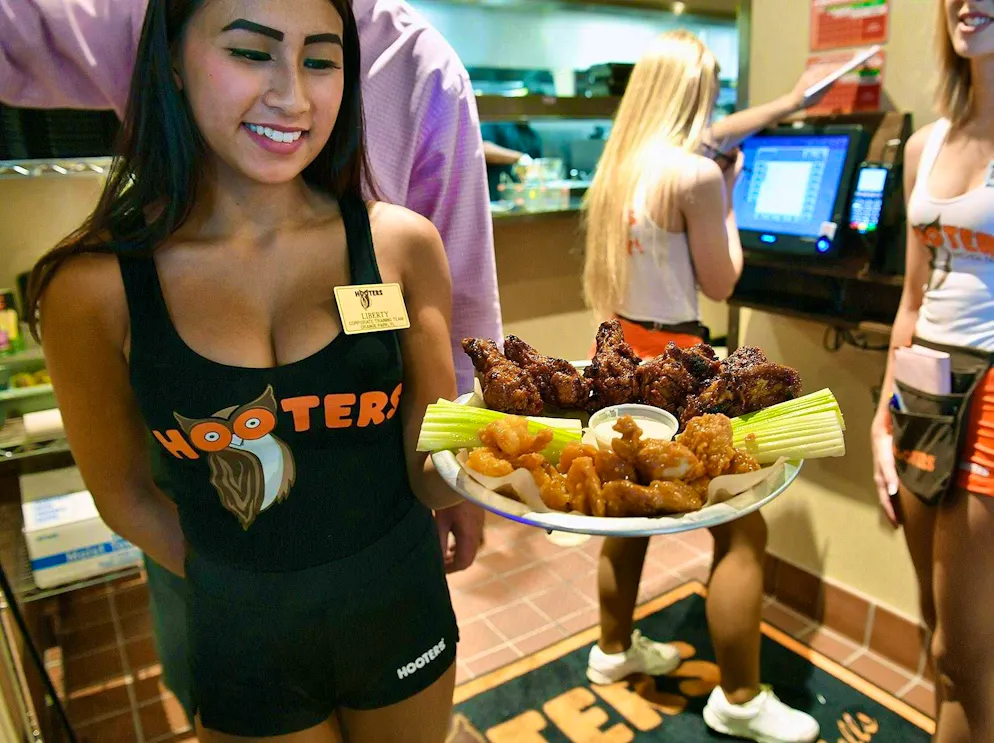 A waitress serves in a Hooters in Palm Beach.