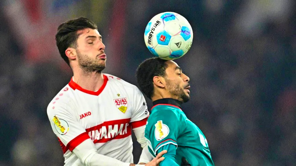 Stuttgart defender Leonidas Stergiou (left) in a header duel with Alexis Claude-Maurice in the Cup quarter-final against Augsburg in February