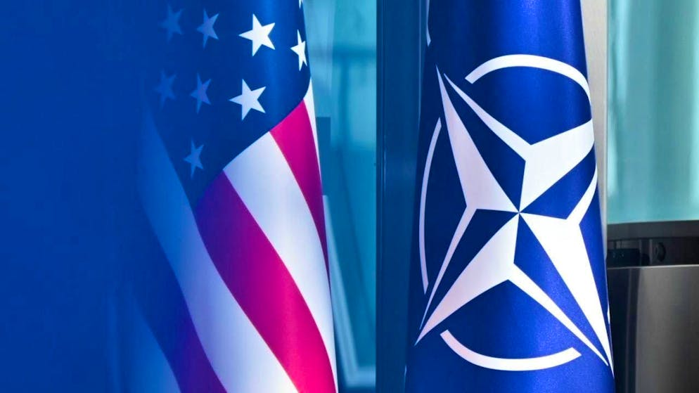 SYMBOL IMAGE - The US flag and the NATO flags stand next to each other at NATO headquarters in Brussels. Photo: Anna Ross/dpa