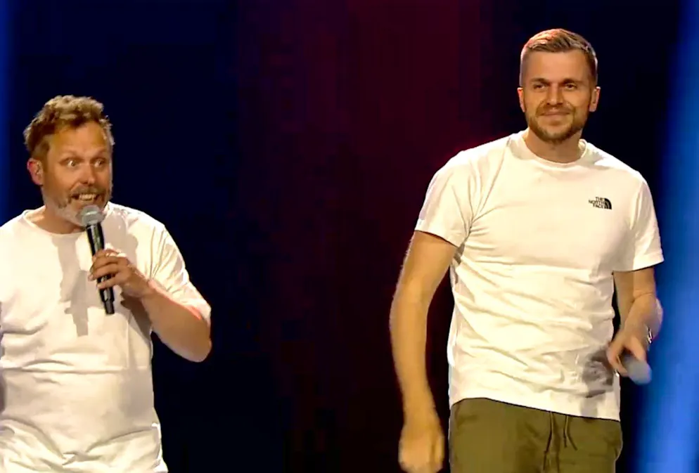 Moser and Schelker dance on stage.