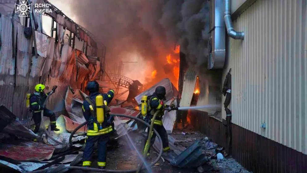 HANDOUT - Rescue workers extinguish a fire after a Russian missile attack. Photo: Uncredited/Ukrainian Emergency Service/AP/dpa - ATTENTION: For editorial use only and only with full citation of the above credit