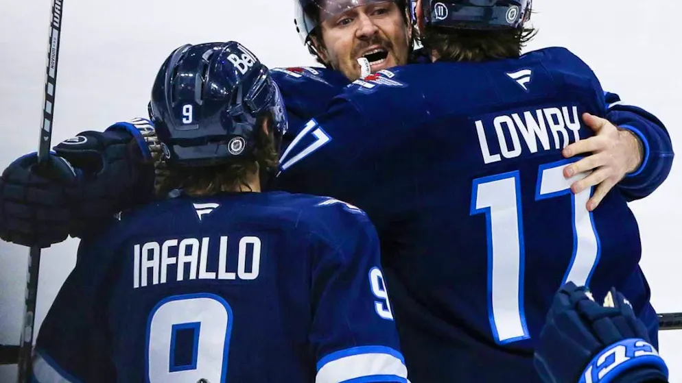 Winnipeg Jets players celebrate their 53rd win of the season