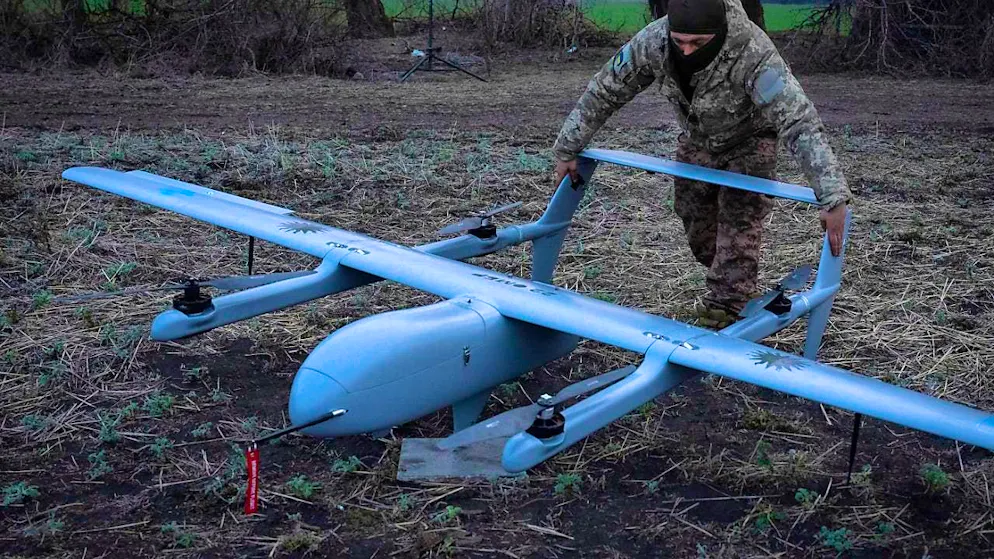 ARCHIVE - A Ukrainian soldier of the 22nd mechanized brigade prepares to launch a Poseidon H10 medium-range drone at the frontline near Bakhmut in the Donetsk region. Photo: Efrem Lukatsky/AP/dpa/Archive