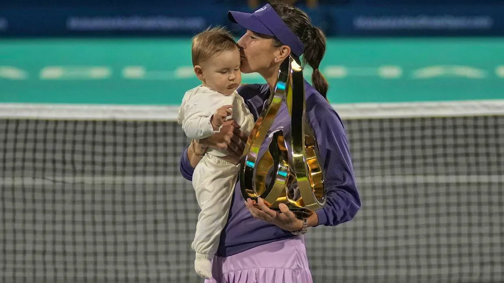 Bencic celebrates her title at the Abu Dhabi Open with her daughter in her arms.