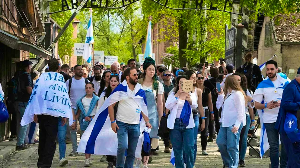 People take part in the "March of the Living", the annual Holocaust memorial event to commemorate the six million Holocaust victims in the former German extermination camp Auschwitz-Birkenau. Photo: Czarek Sokolowski/AP/dpa