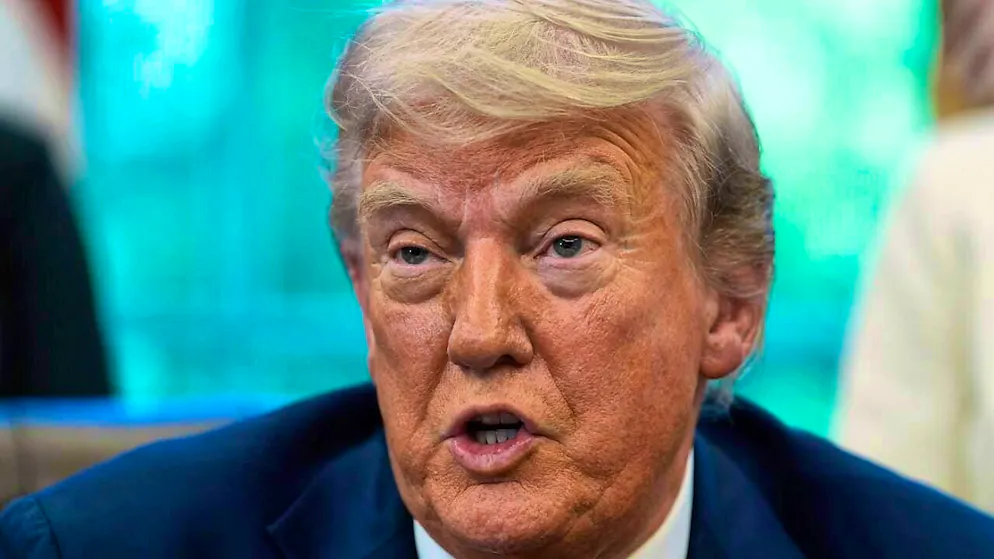US President Donald Trump speaks with reporters after signing executive orders in the Oval Office of the White House in Washington. Photo: Alex Brandon/AP/dpa