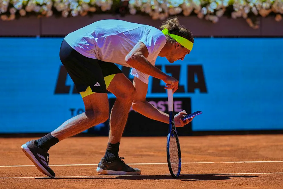 Alexander Zverev pulls out his cell phone and documents a wrong decision.