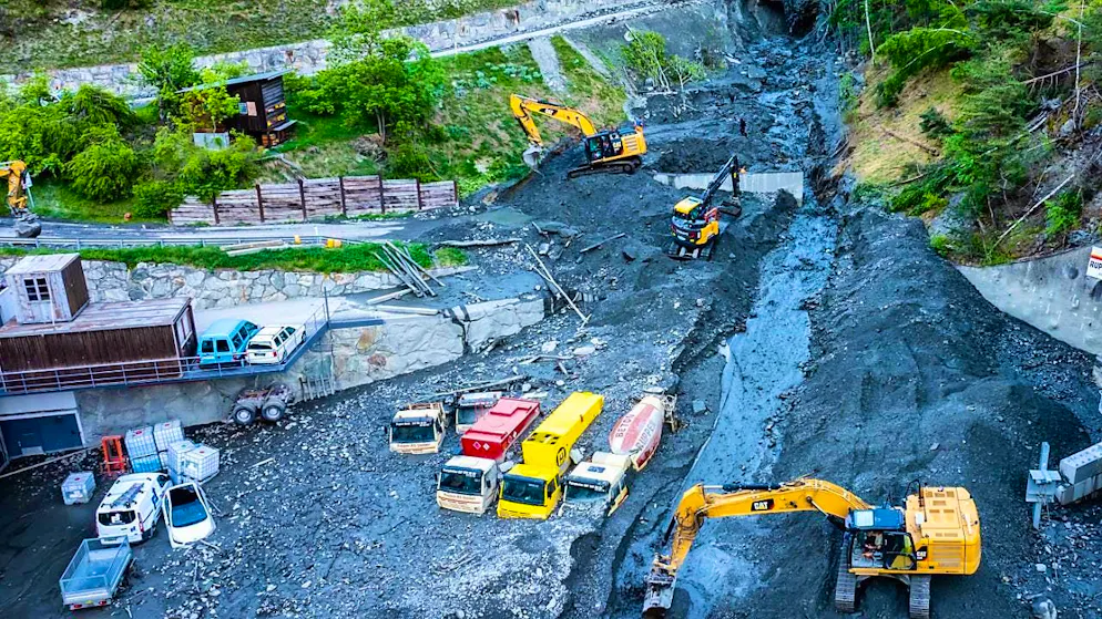 Sections of road and vehicles were buried under debris in the Upper Valais.