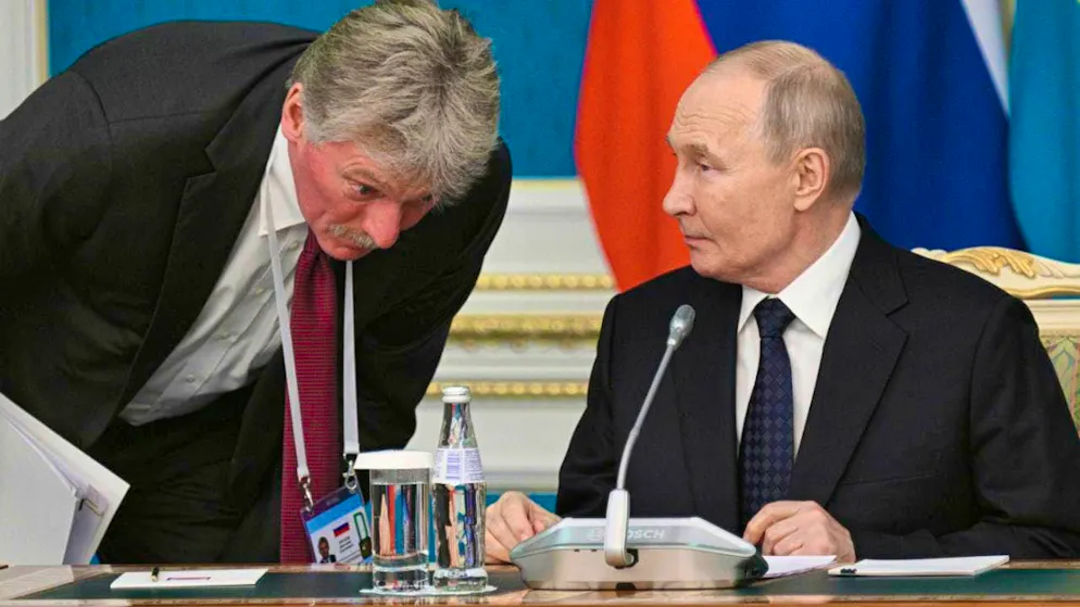 HANDOUT - In this photo released by state news agency Sputnik via AP, Kremlin spokesman Dmitry Peskov, left, listens to Russian President Vladimir Putin before a signing ceremony at the Akorda presidential residence. Photo: Ramil Sitdikov/Pool Sputnik Kremlin/AP/dpa