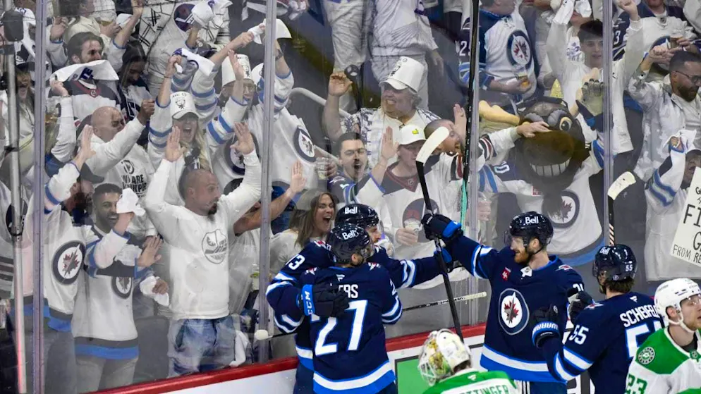 The Winnipeg Jets cheer together with their fans