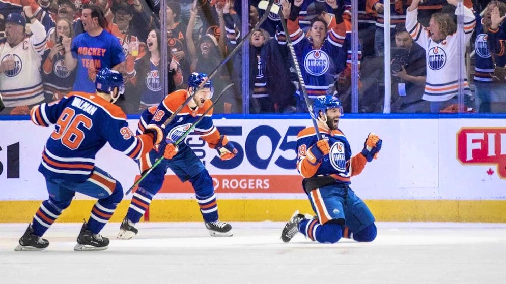 Adam Henrique on his knees celebrating the 2-0 win for Edmonton