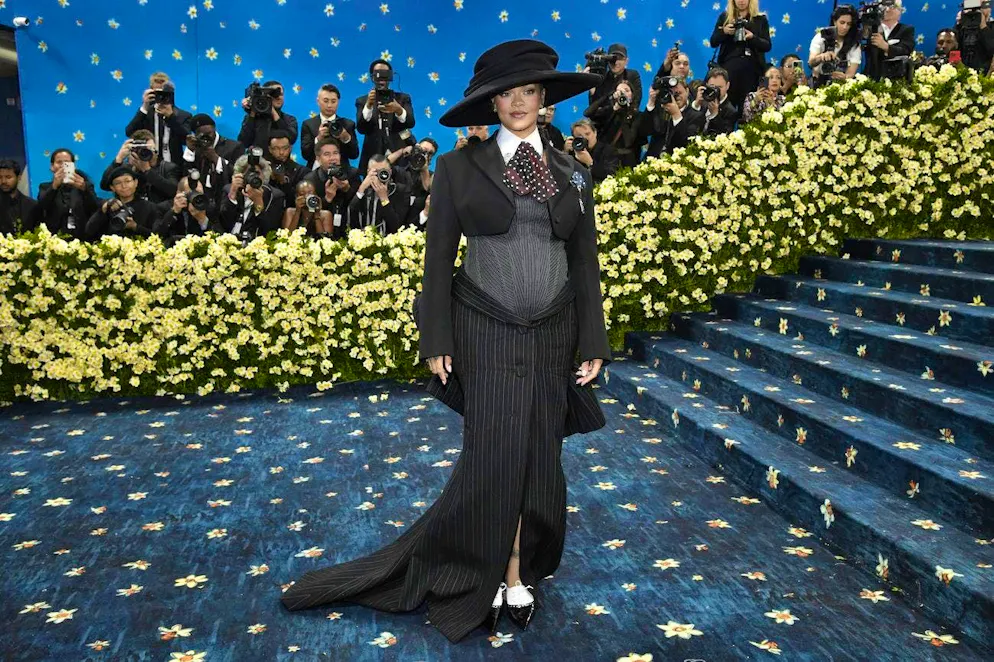 Rihanna - la sfilata di moda in gravidanza è iniziata!. Ha annunciato la sua gravidanza con il botto, indossando un outfit stravagante al Met Gala, probabilmente l'evento di moda più emozionante dell'anno. Per l'evento, incentrato sulla moda maschile e sulla storia del dandismo nero, ha indossato una creazione di Marc Jacobs: una gonna sartoriale a righe nere e una giacca di lana tagliata, sotto la quale un bustier a rete metteva perfettamente in evidenza il pancione.