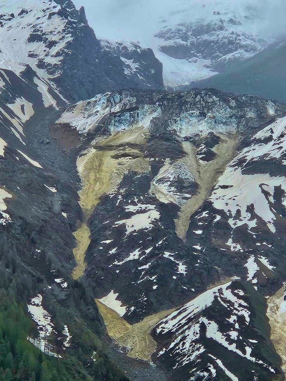 Stones from a rockslide from the Kleine Nesthorn fall onto the Birch Glacier in the Lötschental on Saturday